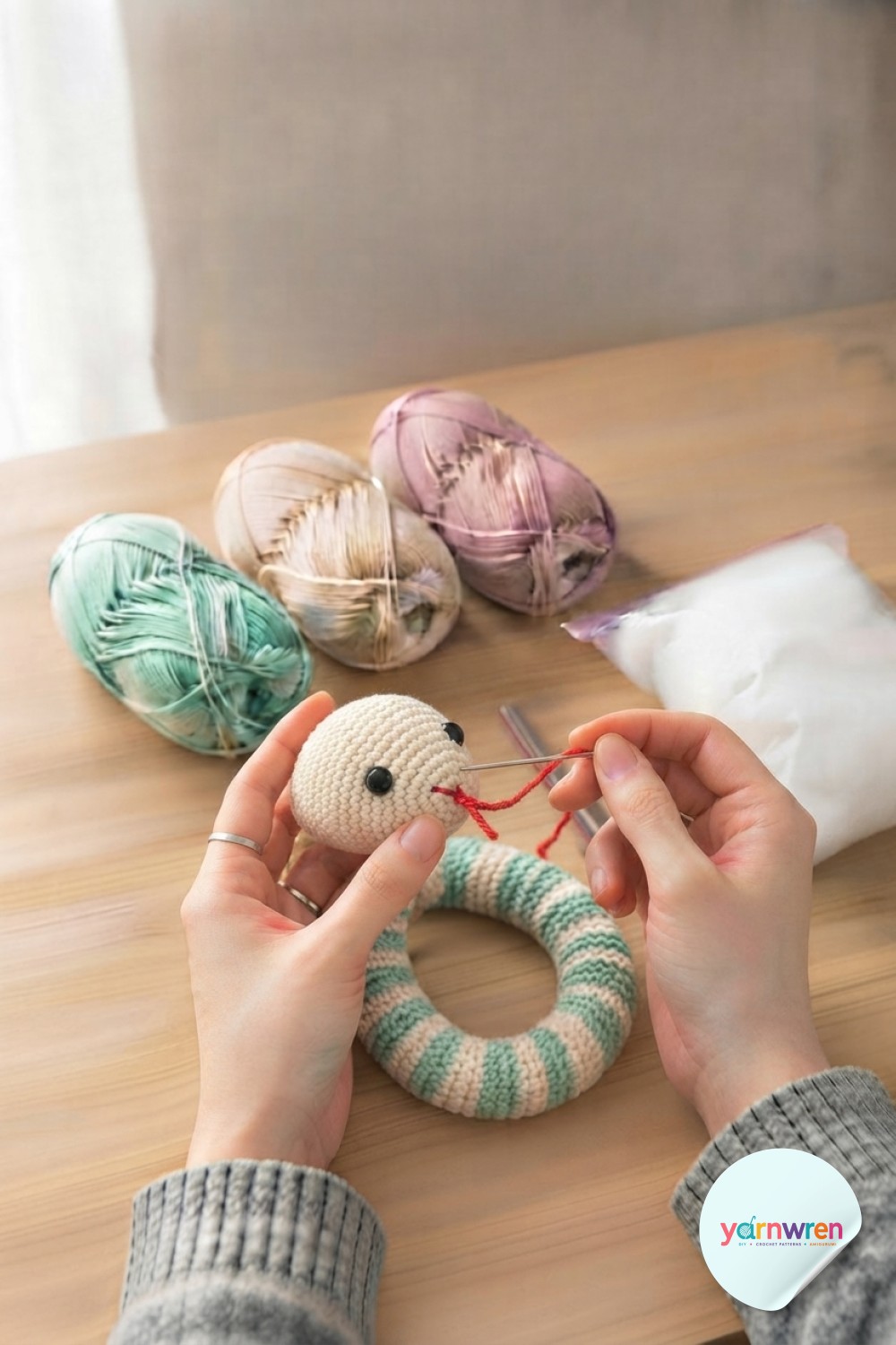 Safety eyes and a red forked tongue bring personality to this crochet snake amigurumi pattern's finished head.