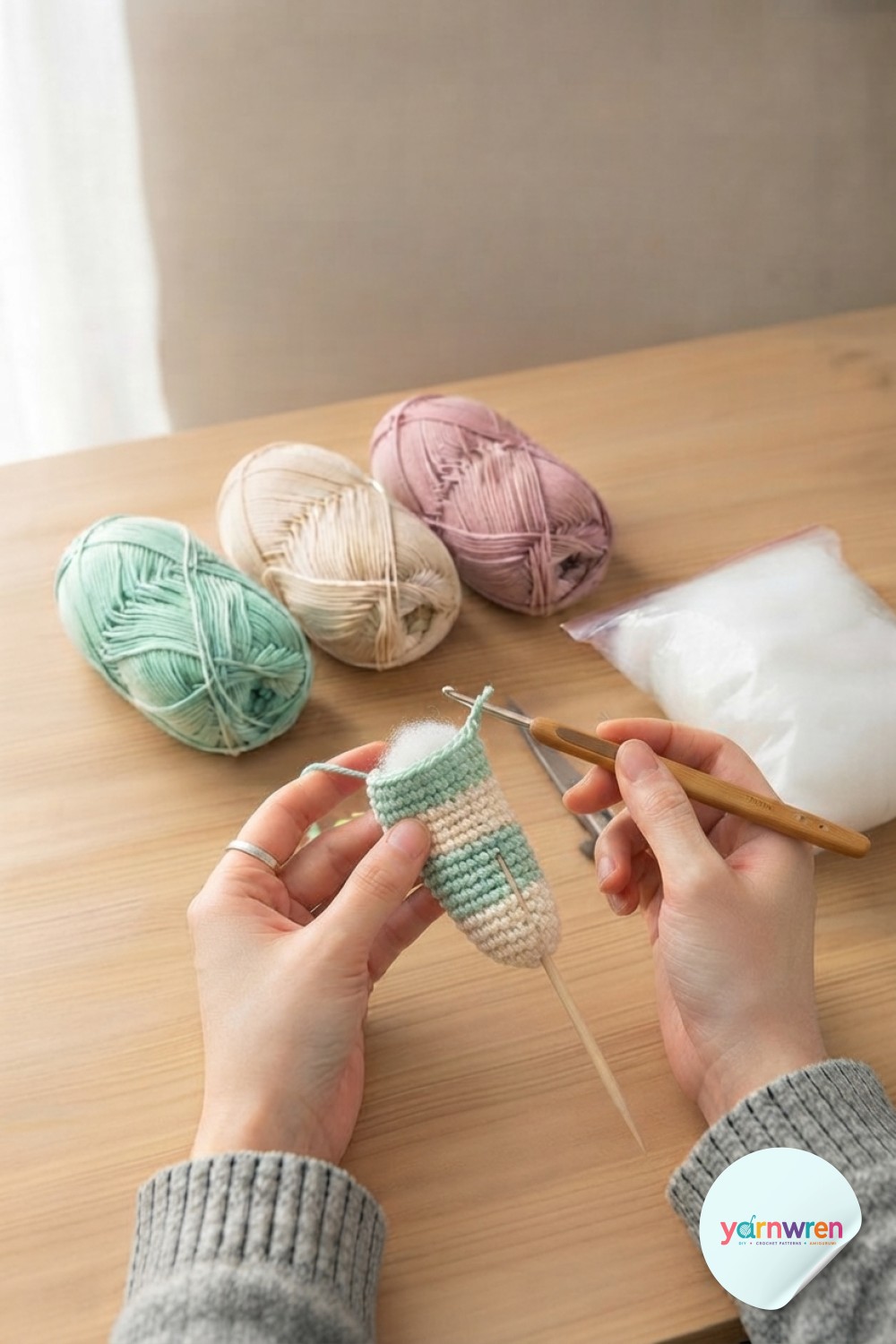 Switching from mint to cream yarn begins the striped body central to this crochet snake amigurumi pattern.